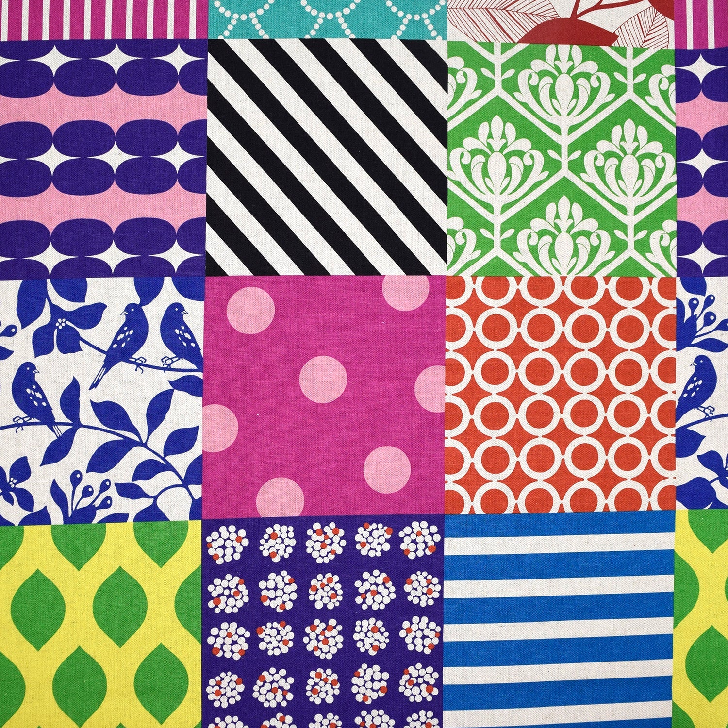 The image is a vibrant patchwork of various colorful and patterned fabric squares, creating a visually striking and diverse composition.
