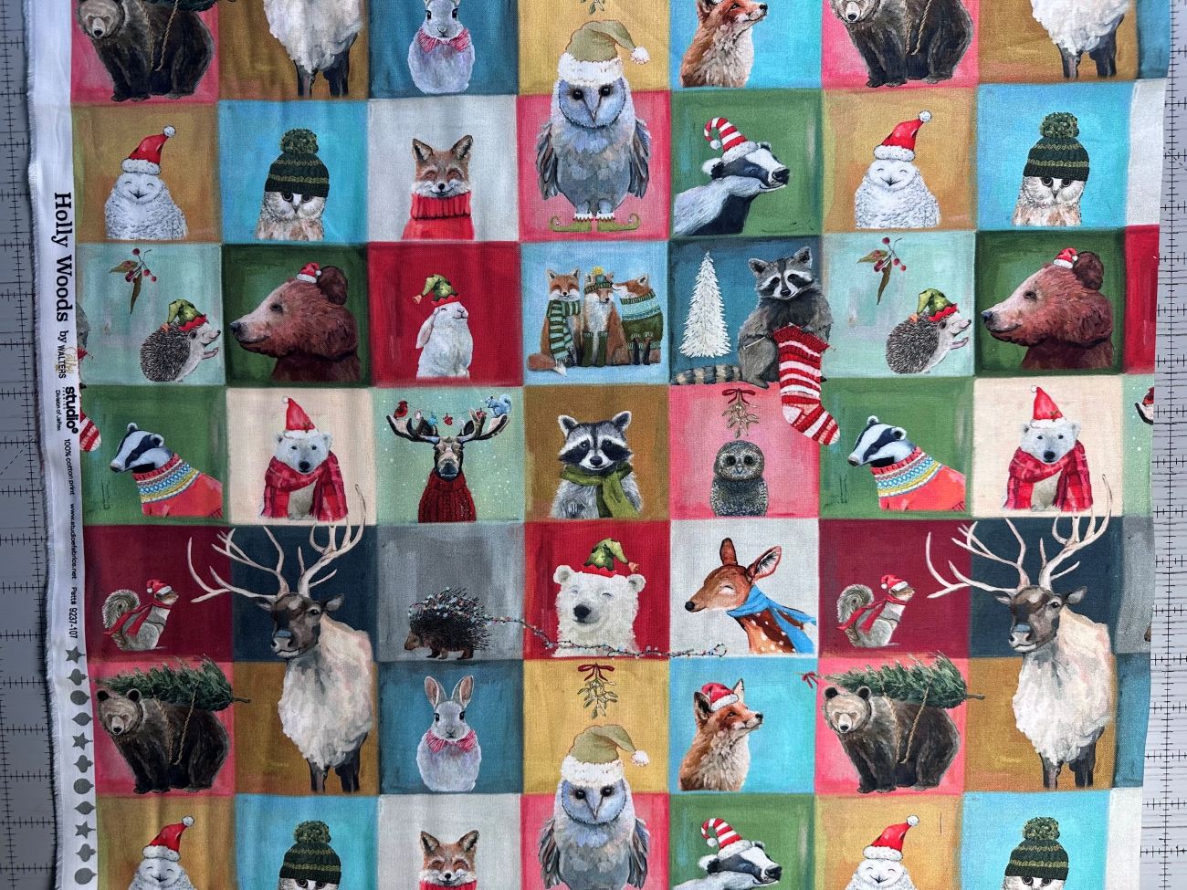 The image is a collage of various animal illustrations, including a bear, owl, raccoon, deer, moose, and other animals, all wearing festive hats and scarves.