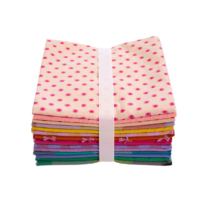 A bundle of colorful fabric pieces tied together, with a white ribbon around them.