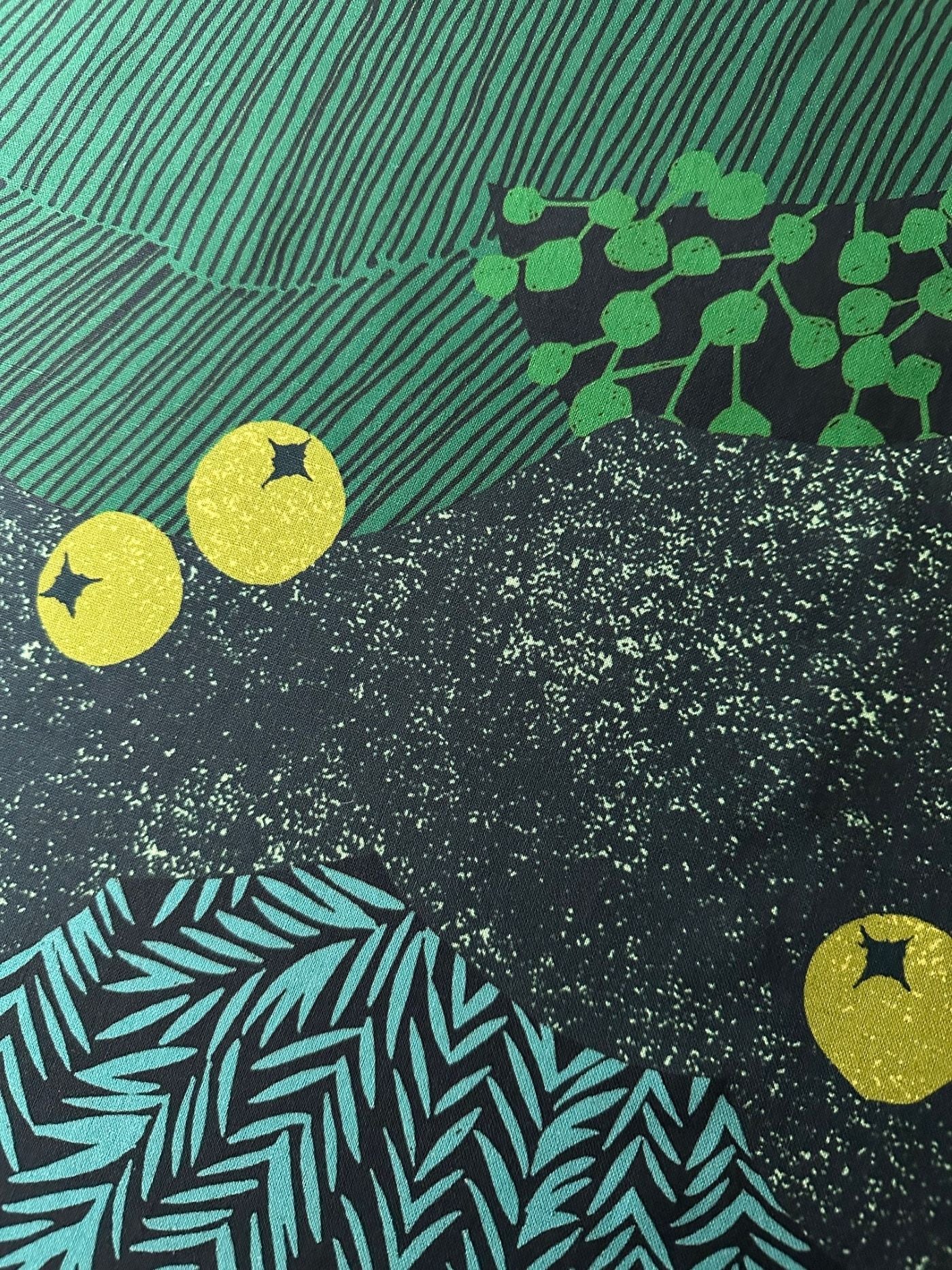 The image is a collage of various abstract patterns and shapes, including yellow circles, green leaves, and black and green stripes.
