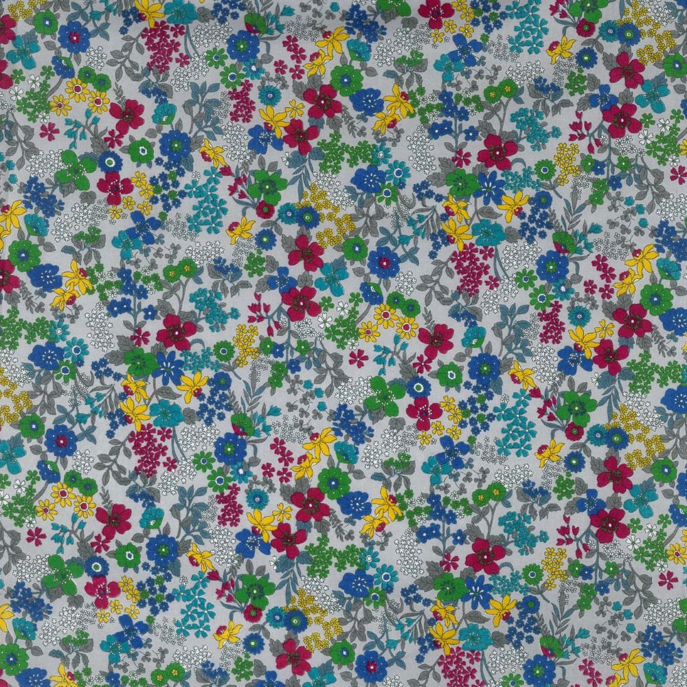 The image is a collage of various colorful flowers and leaves in different shades of blue, green, yellow, and red. The flowers are scattered throughout the image, creating a vibrant and lively pattern.