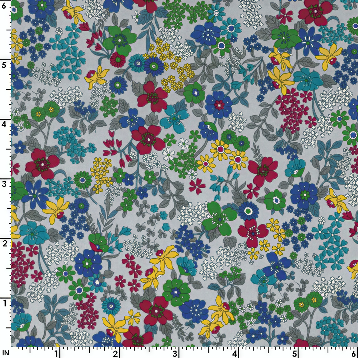 The image is a collage of various colorful flowers and leaves in different shades of blue, green, yellow, and red. The flowers and leaves are scattered across the image, creating a vibrant and lively pattern.