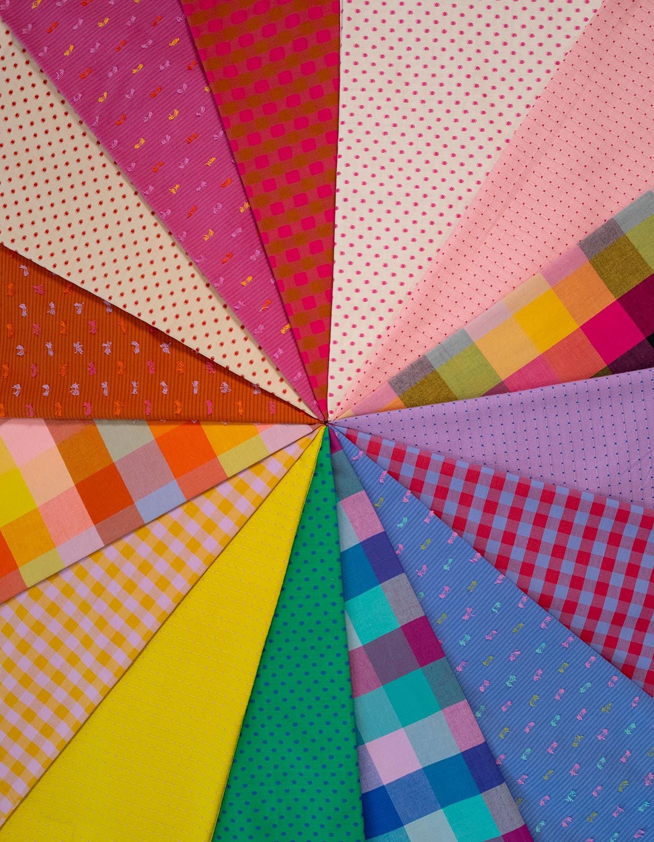 The image is a vibrant collage of various colorful fabric patterns, including polka dots, stripes, plaid, and checkered designs, arranged in a radial pattern.