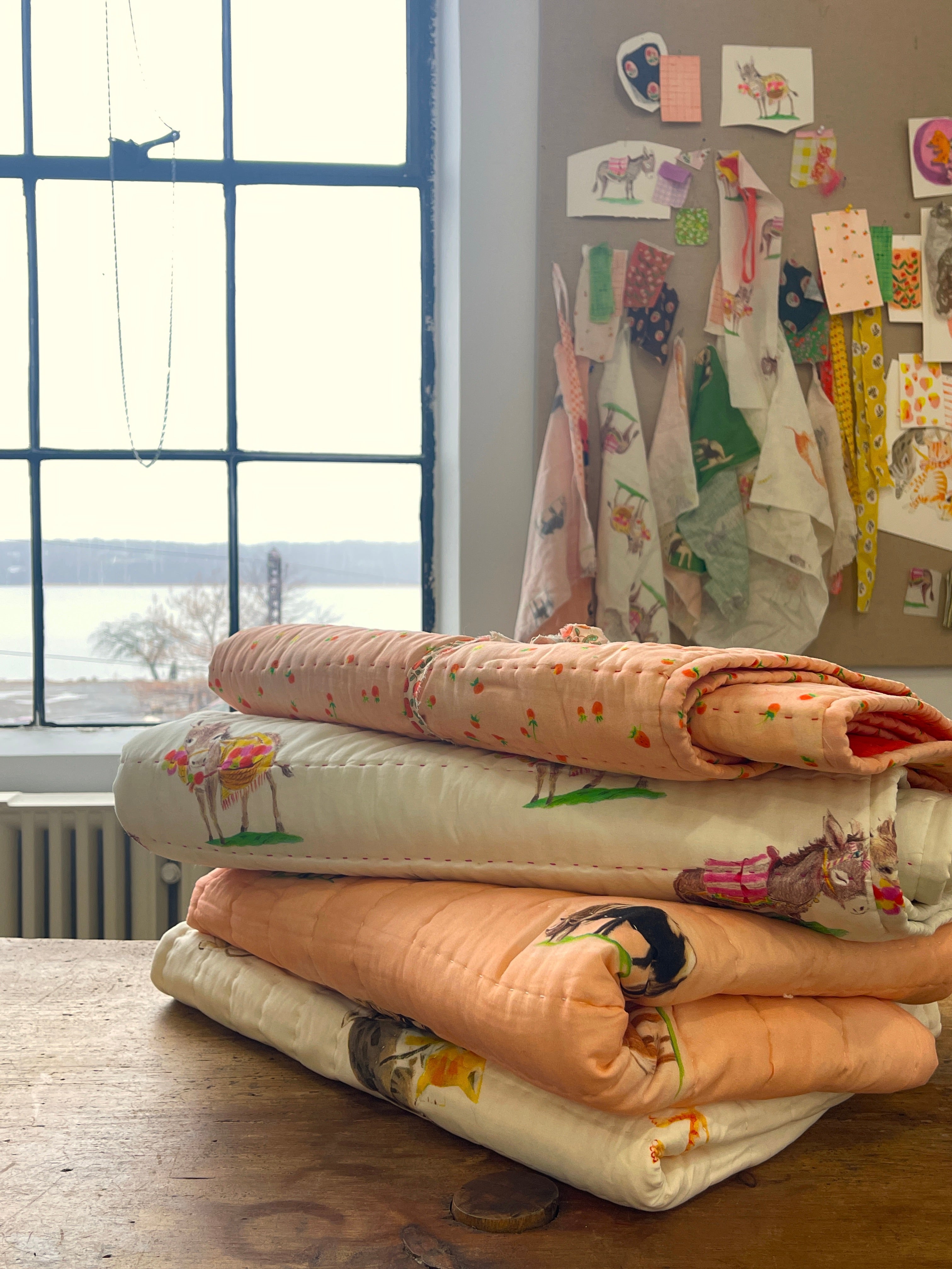a stack of cloths sitting on top of a wooden table