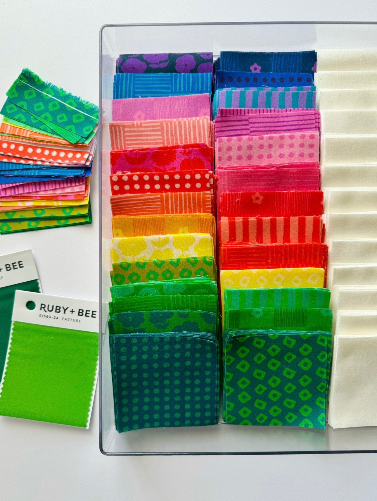 a bunch of different colors of fabric on a table