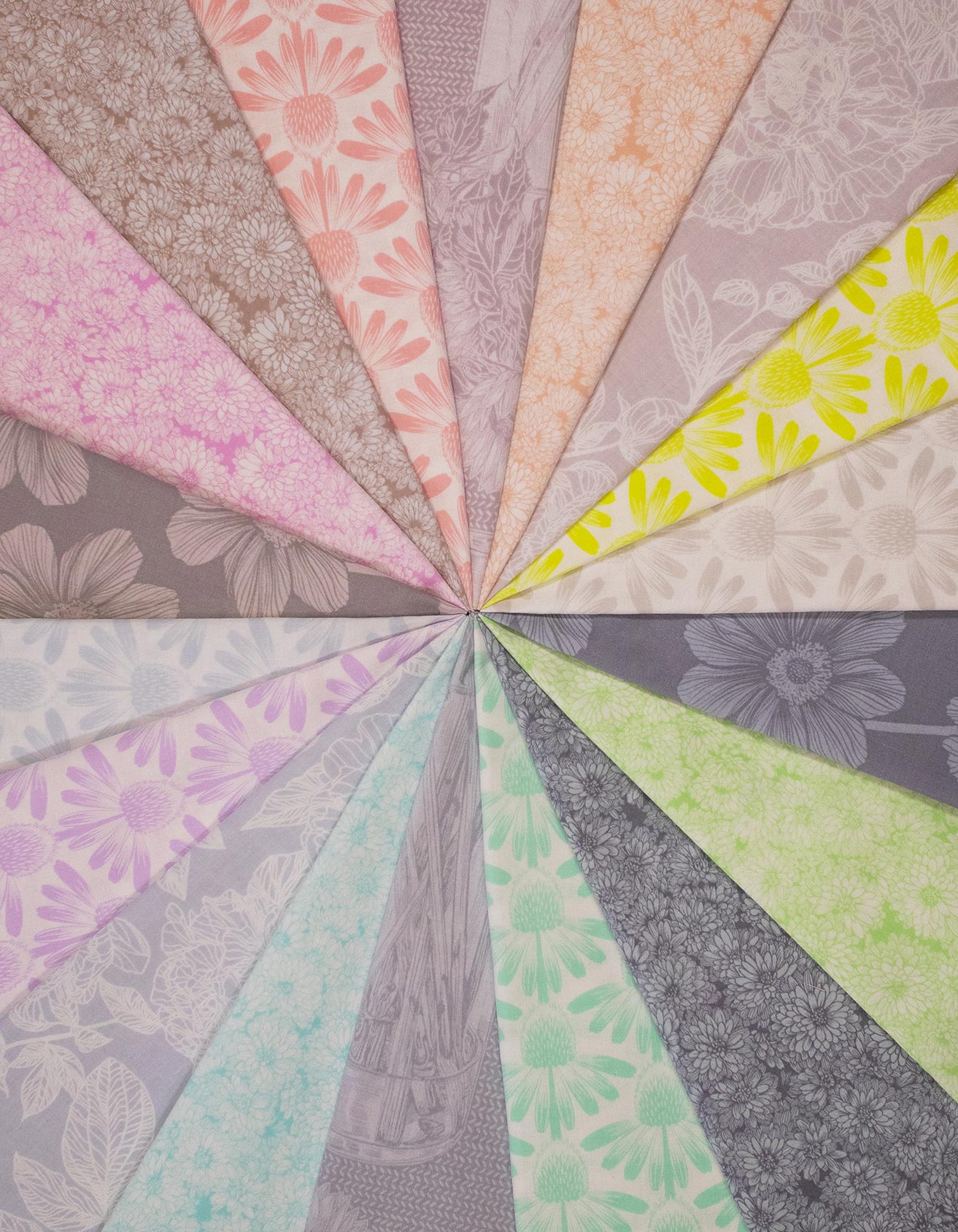 The image is a vibrant and colorful arrangement of various fabric patterns, including floral and geometric designs, creating a visually striking and diverse composition.