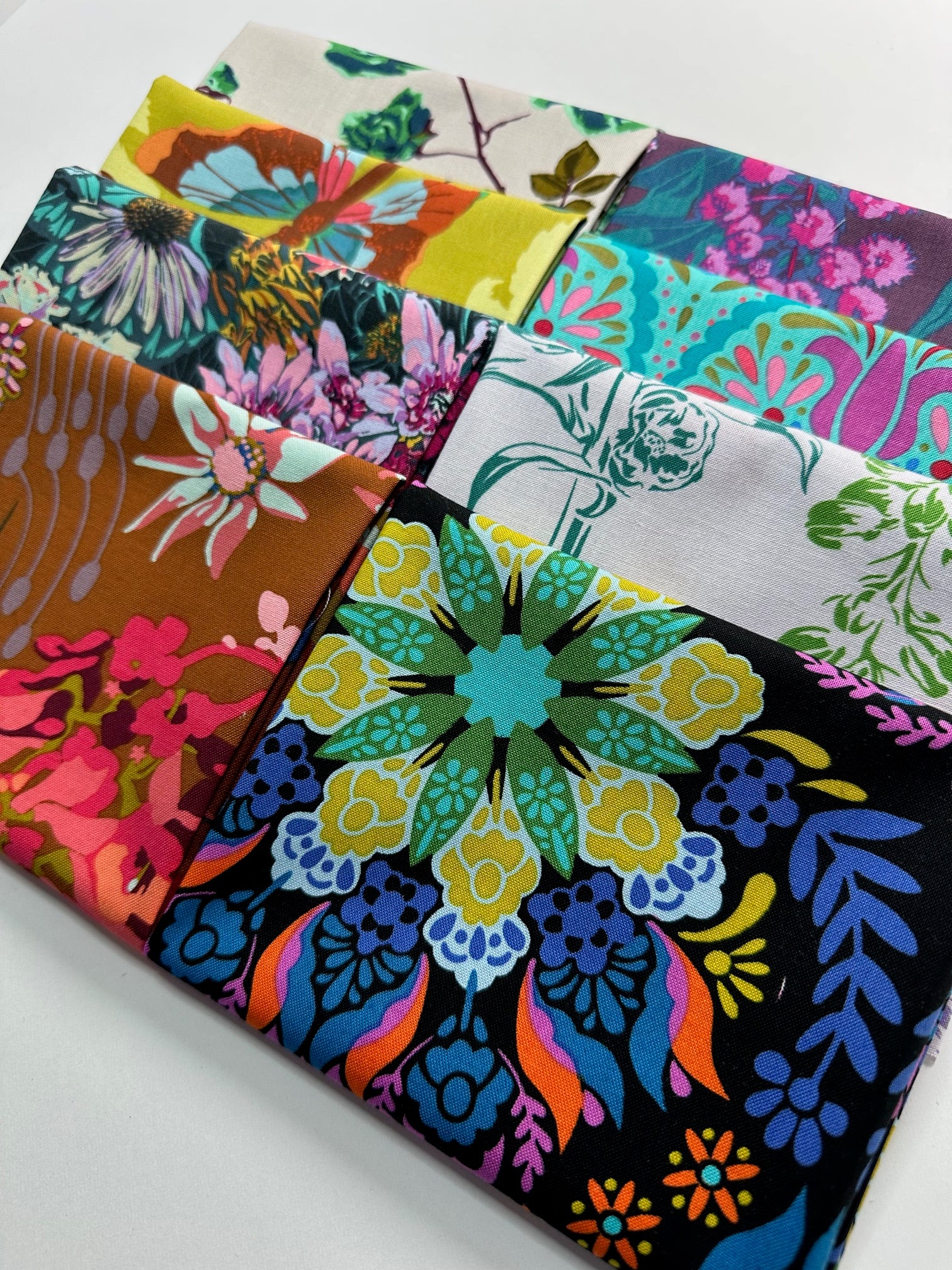a collection of colorful fabric swatches, each with unique floral and abstract patterns.