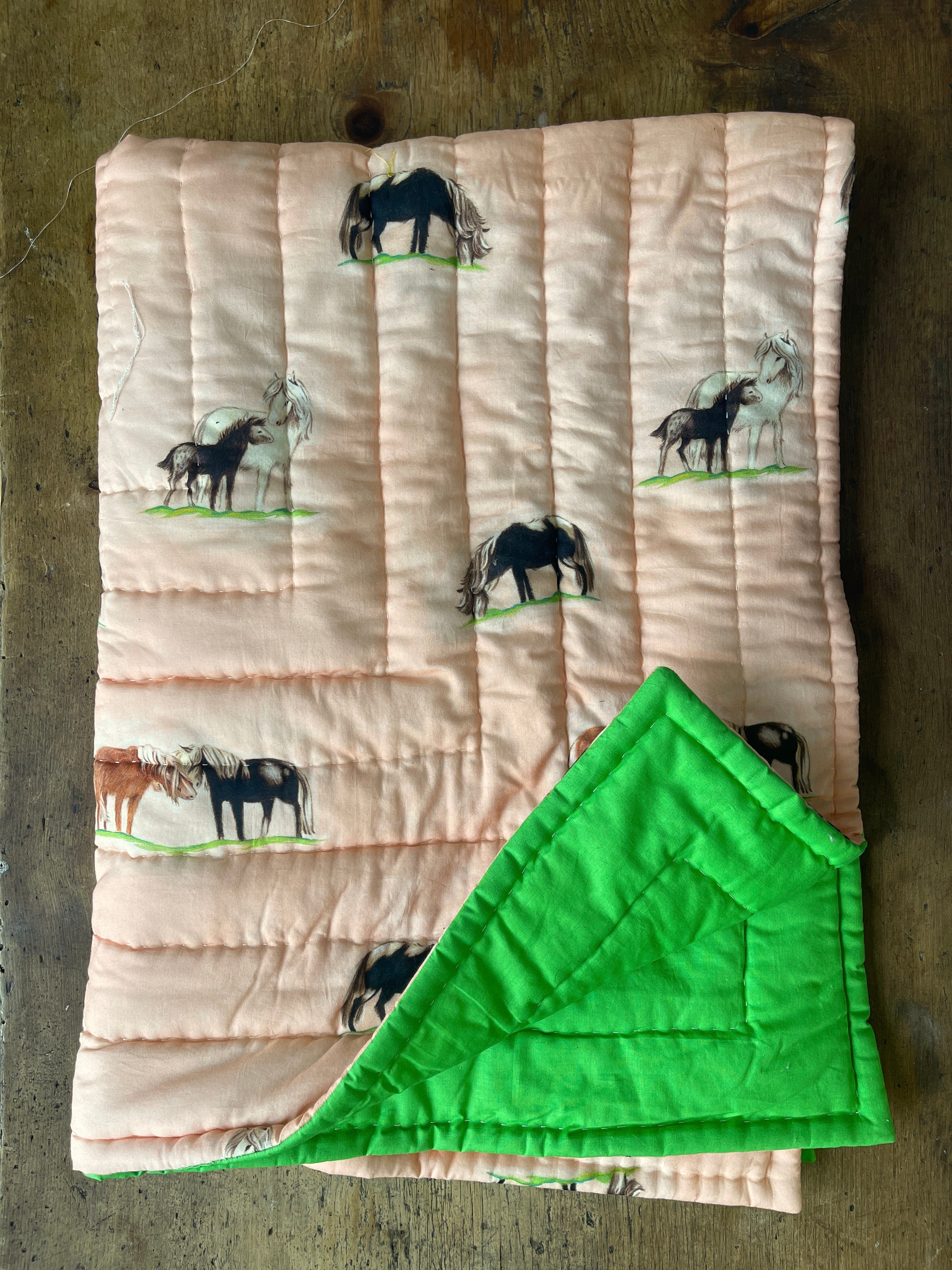 a quilted blanket with horses on it