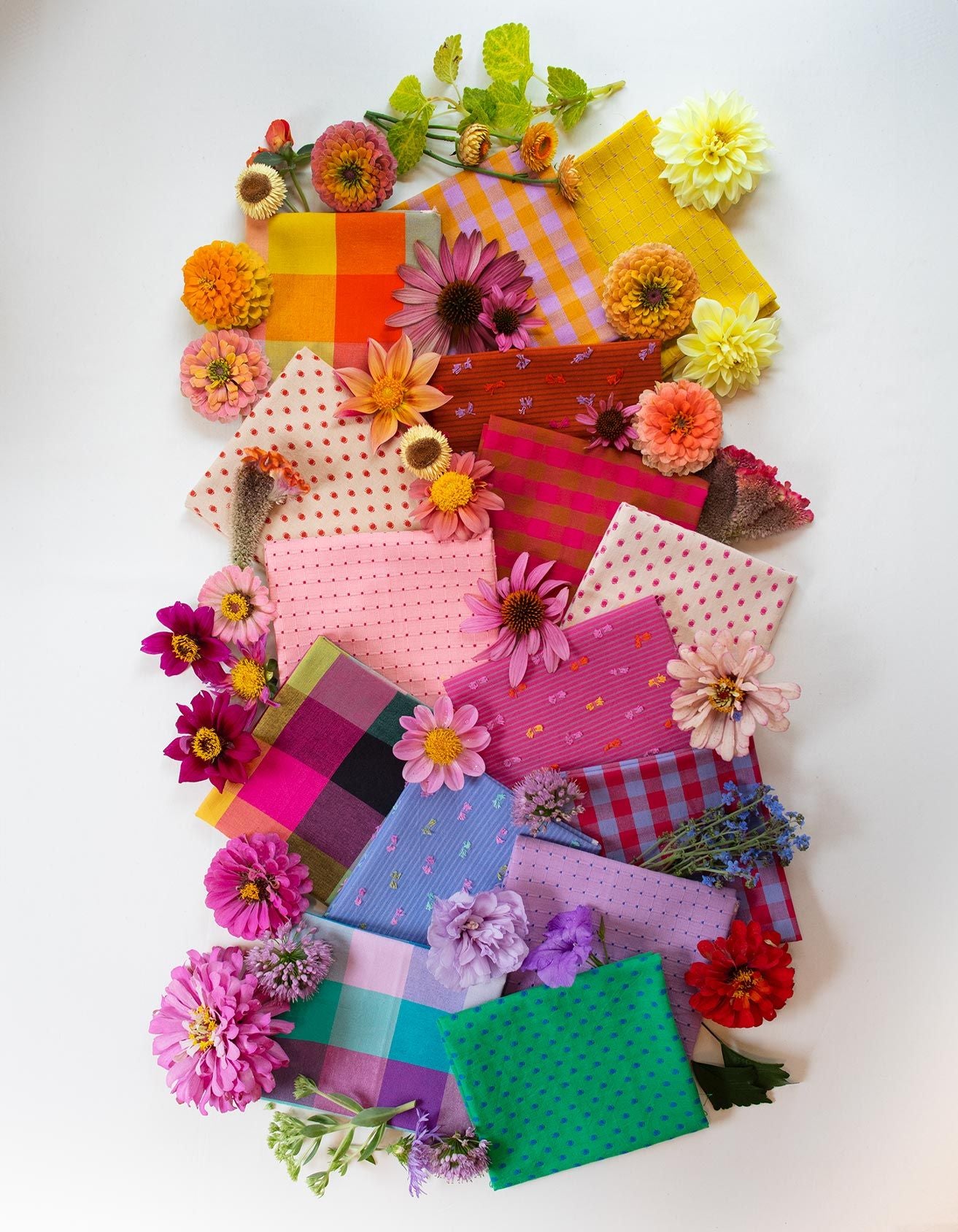a vibrant display of colorful fabric swatches and flowers arranged in a visually appealing manner.