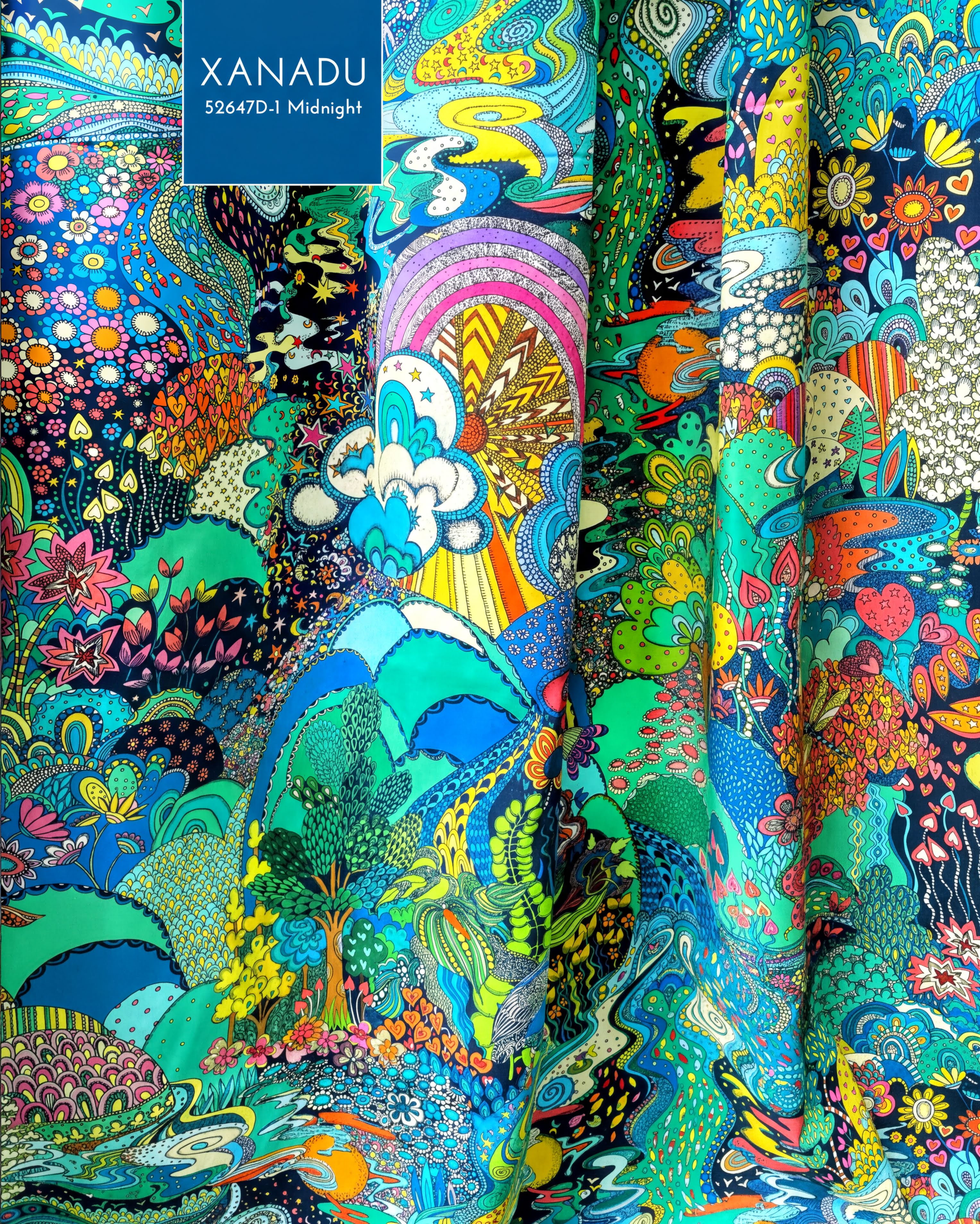 The image is a vibrant and colorful fabric with a variety of patterns and designs, including flowers, leaves, and abstract shapes. The fabric appears to be a textile or material with a lively and dynamic appearance, possibly used for clothing or home decor.