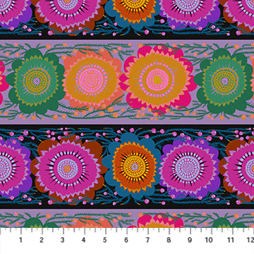 The image is a vibrant and colorful pattern featuring a repeating design of large, stylized flowers in shades of pink, orange, yellow, and green. The flowers are arranged in a diagonal pattern, creating a sense of movement and energy across the image. The pattern is set against a dark background, which highlights the bright colors of the flowers and makes them stand out prominently.