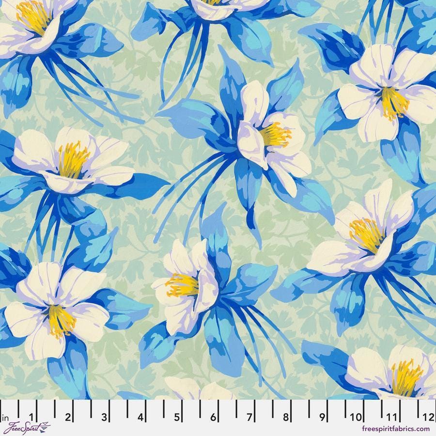 a blue and white flower on a green background