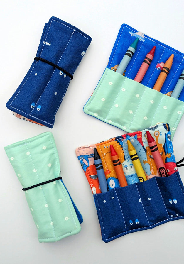 a set of four pencils and markers in a pouch