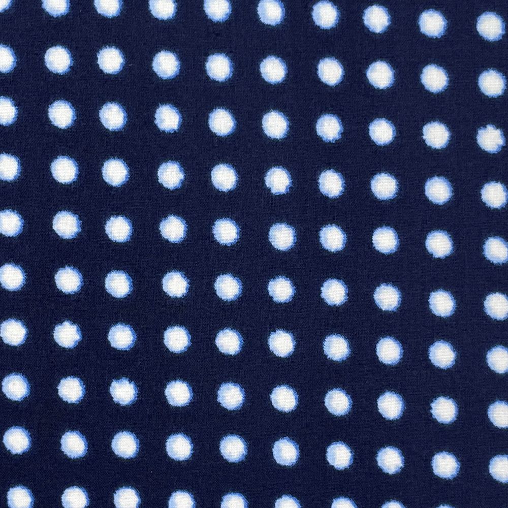 a close-up view of a dark blue fabric with a repeating pattern of white polka dots.