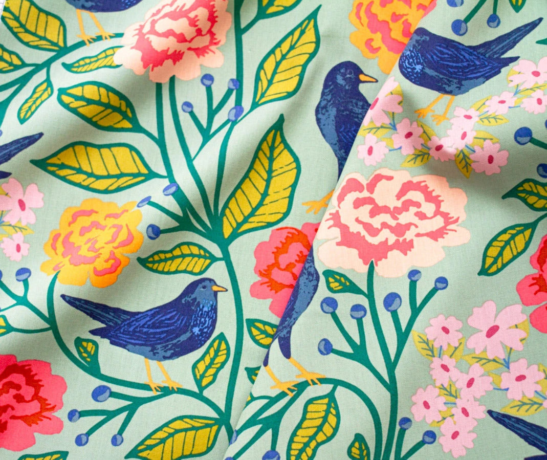 a vibrant and colorful floral pattern with various flowers, leaves, and birds.