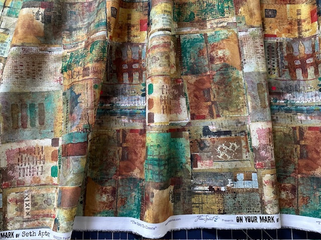 The image is a close-up of a fabric with a colorful, abstract pattern. The fabric appears to be a piece of clothing or textile, with a variety of colors and shapes creating a visually striking design.