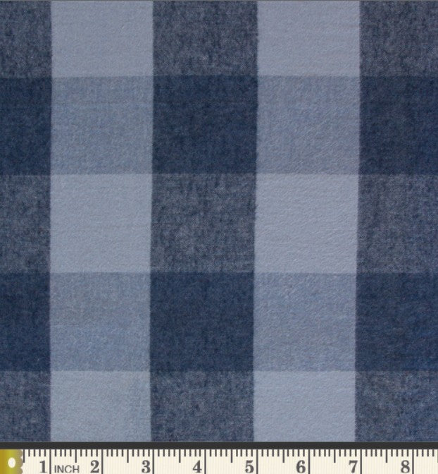 a close-up view of a fabric with a blue and white checkered pattern. The fabric appears to be made of a material with a textured surface, giving it a somewhat rough appearance. The fabric is displayed on a ruler for scale, indicating its size.