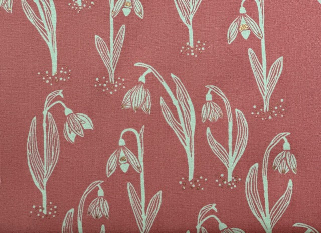 a repeating pattern of white snowflakes on a red background.