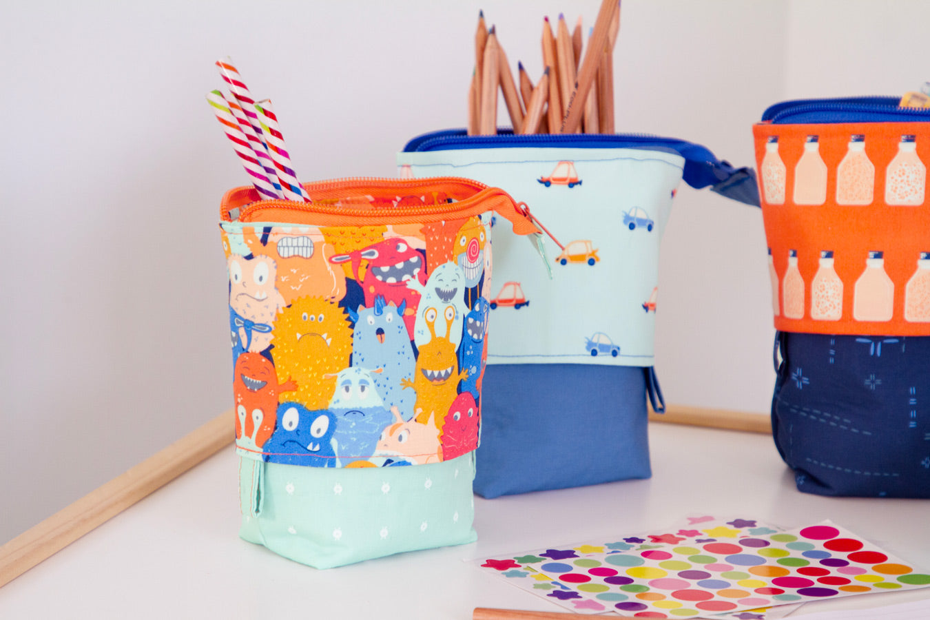 three colorful bags sitting on top of a table