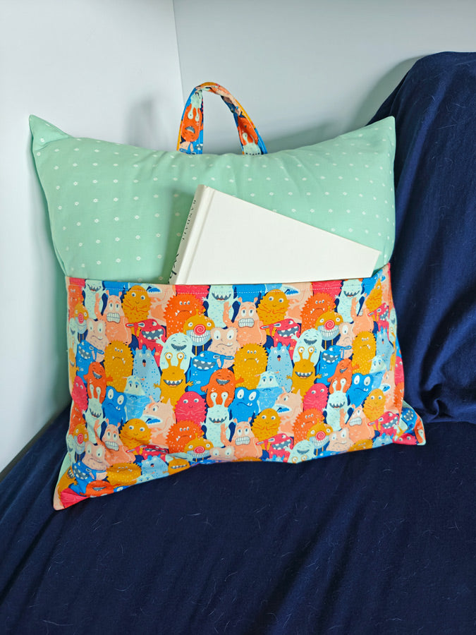 a pillow with a book on top of it