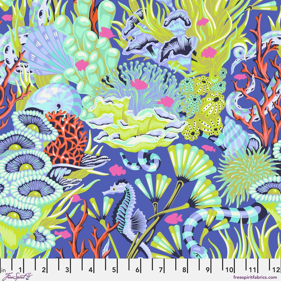 The image is a vibrant and colorful underwater scene featuring various marine life, including a seahorse, coral, and fish, all set against a deep blue background.