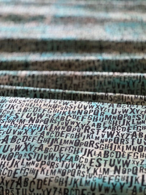 a repeating pattern of various letters of the alphabet, creating a visually striking and textured effect.