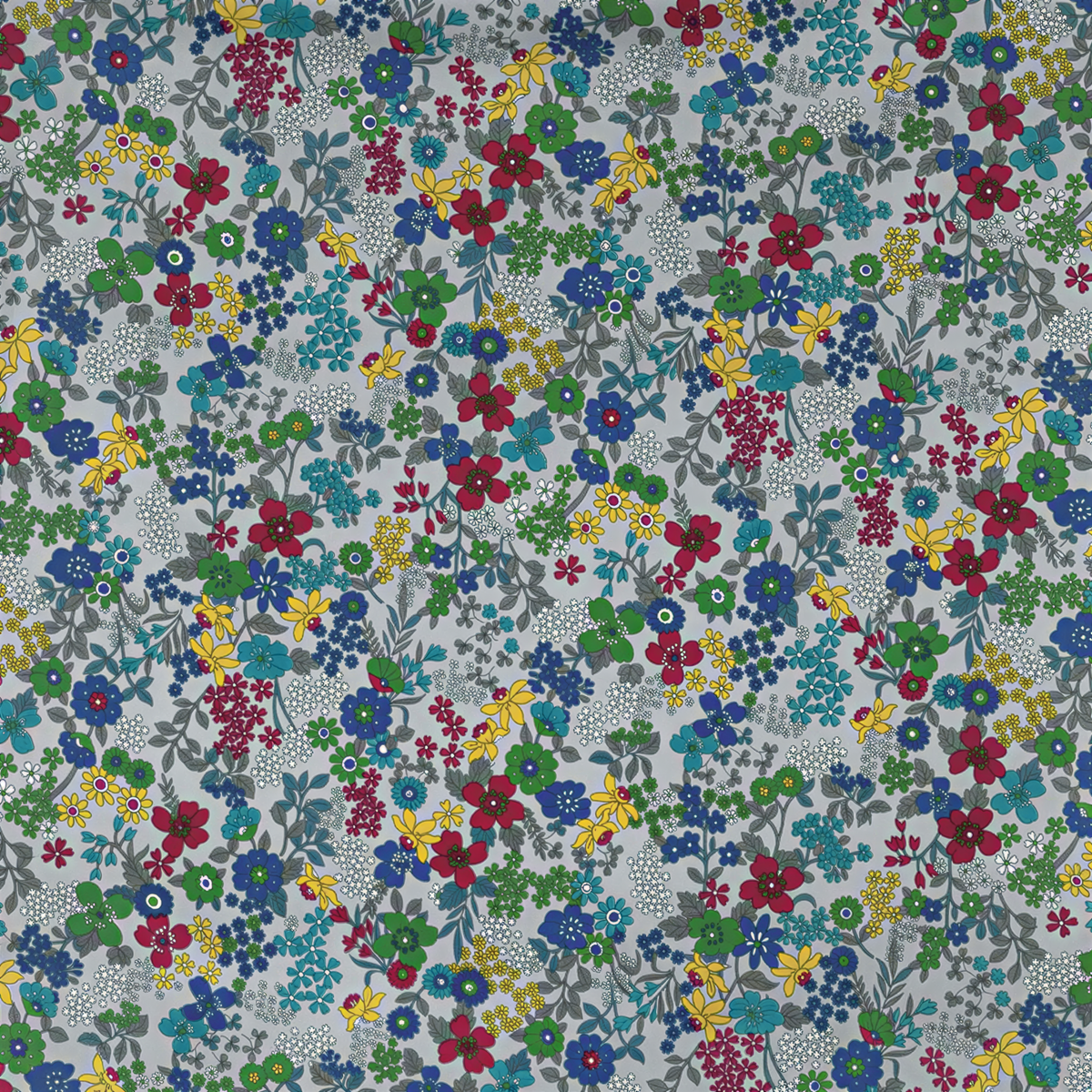 The image is a collage of various colorful flowers and leaves in different shades of blue, green, yellow, and red. The flowers are scattered throughout the image, creating a vibrant and lively pattern.