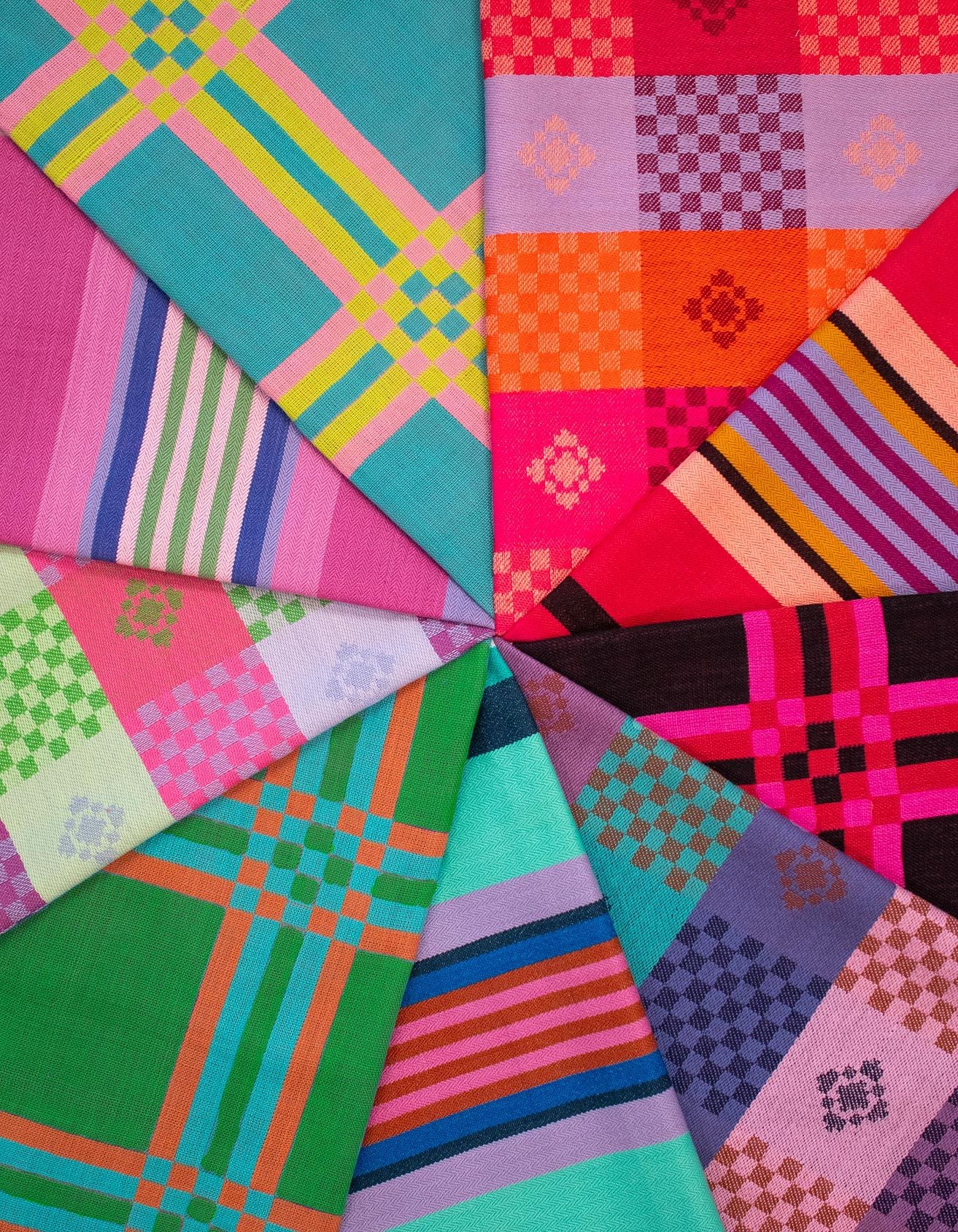 a vibrant array of colorful fabrics, each with unique patterns and designs, arranged in a circular pattern.