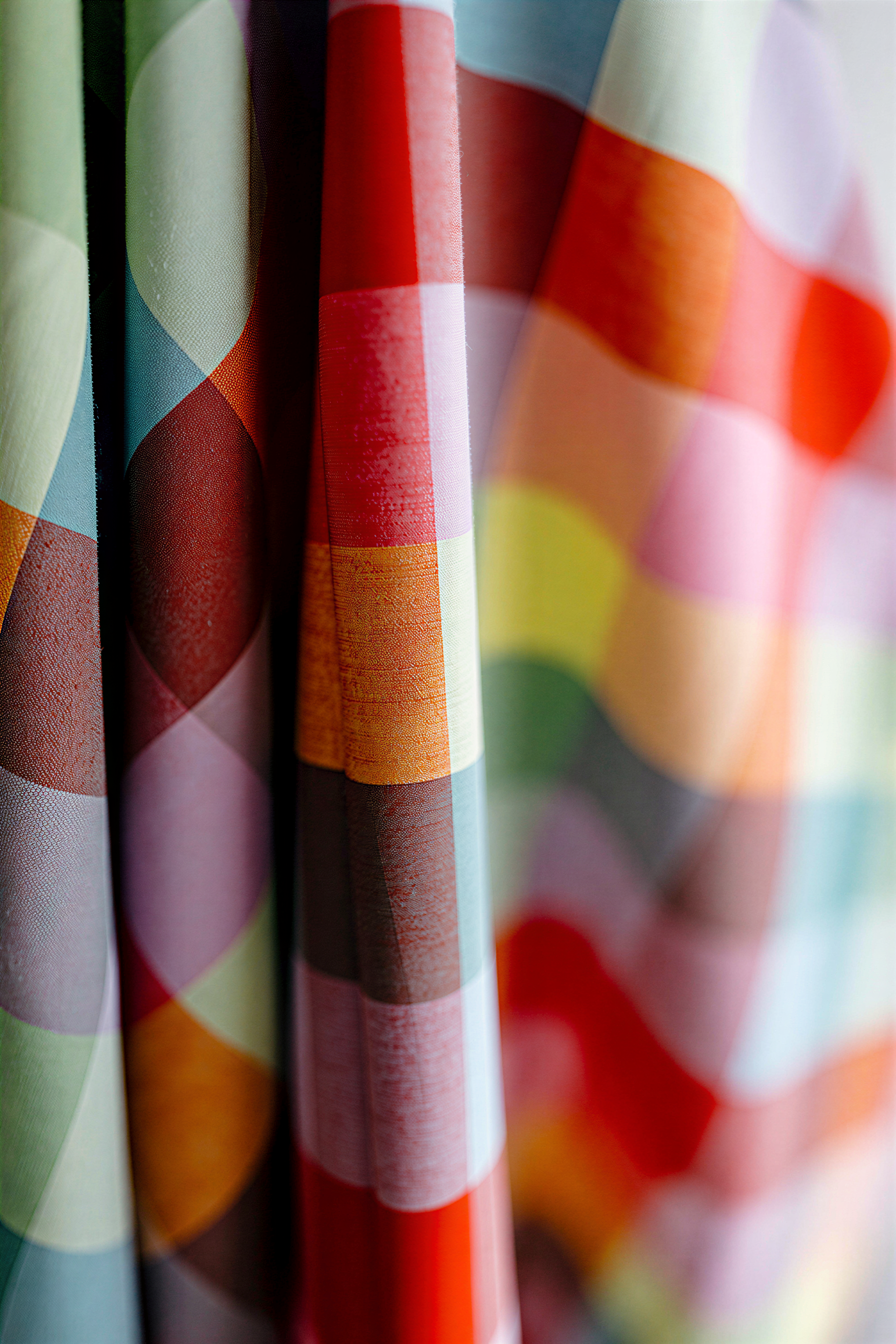 a close-up view of a colorful, multicolored fabric, with a vibrant pattern of stripes and shapes.