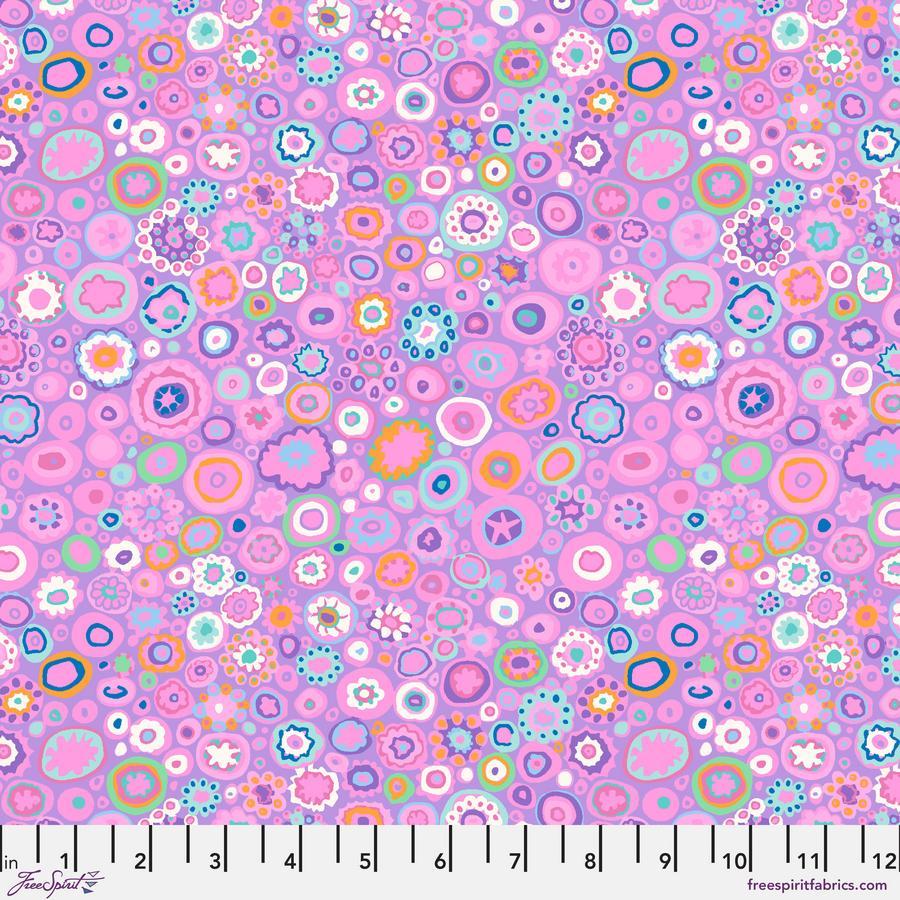 The image is a vibrant and colorful abstract pattern composed of various shapes, including circles, ovals, and other geometric forms, in shades of pink, blue, green, and orange. The pattern appears to be a repeating design, creating a visually striking and dynamic composition.
