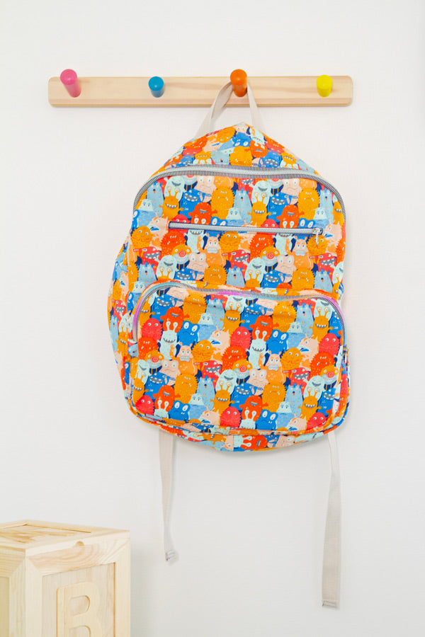 a colorful backpack hanging on a wall