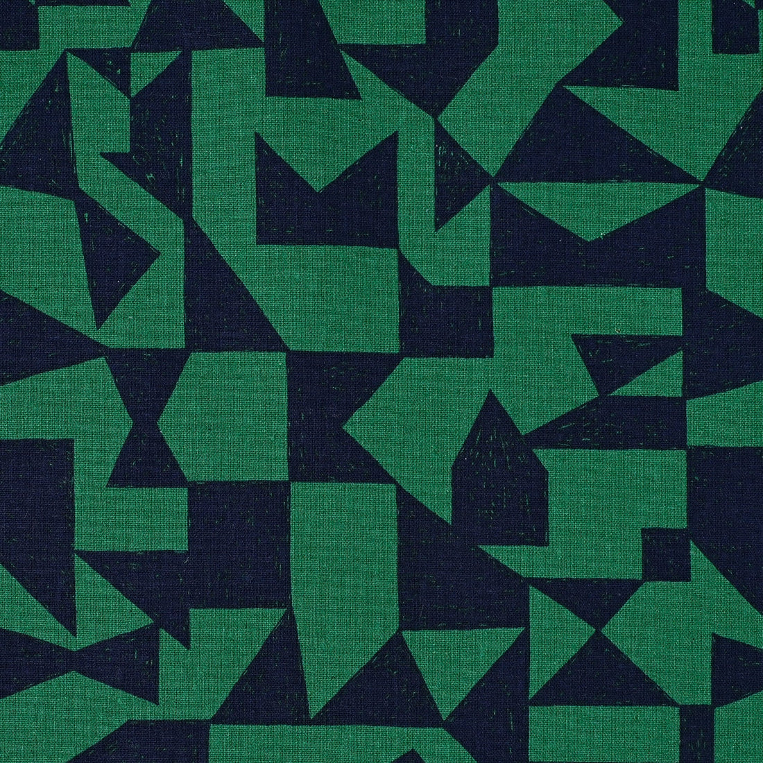 a close-up view of a fabric with a geometric pattern composed of various shades of green and navy blue triangles.