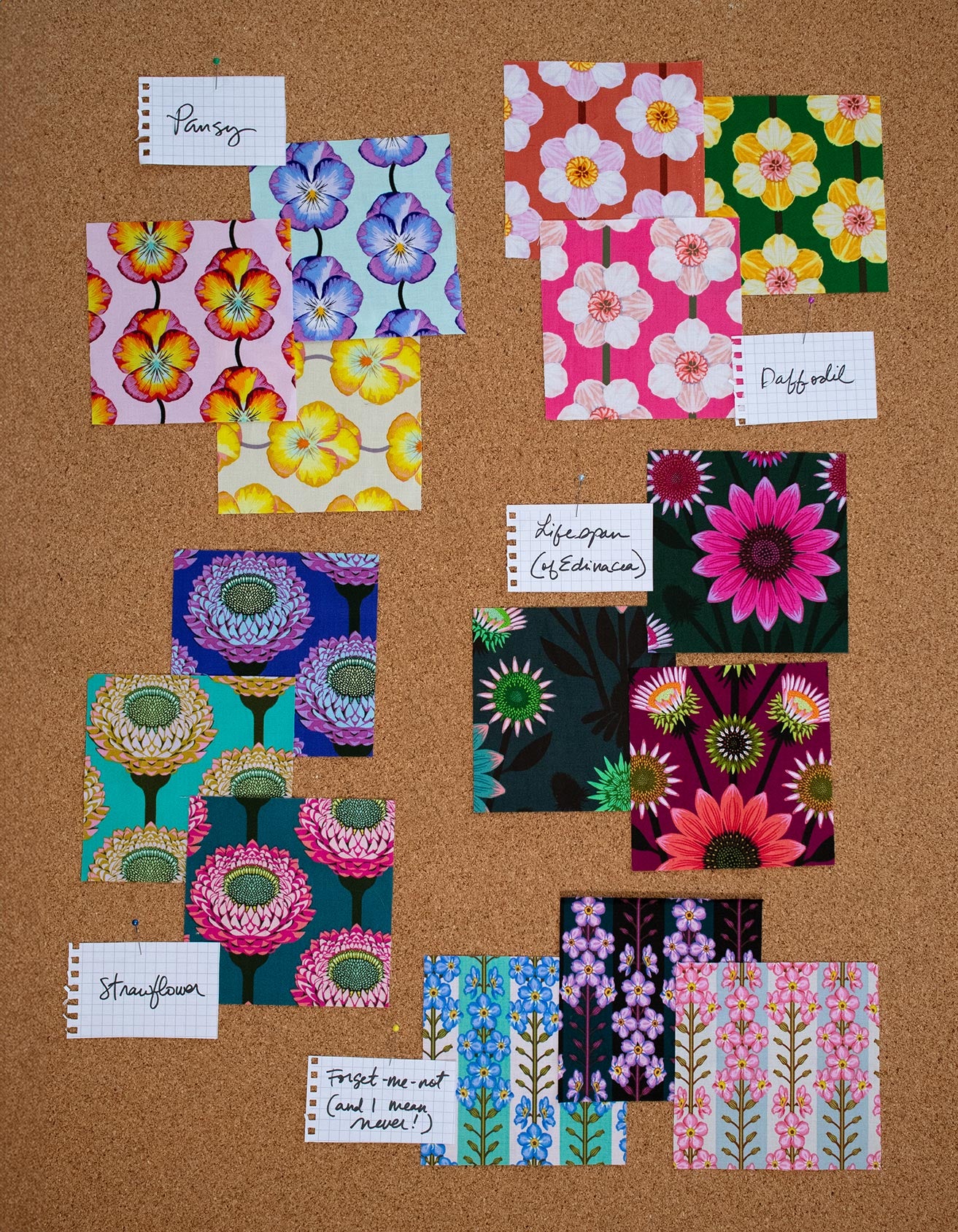 a cork board covered in lots of different colored papers