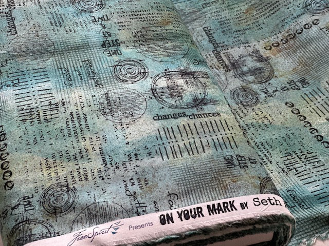 The image is a close-up of a fabric with a pattern of circles and lines, along with some text. The text appears to be related to the fabric's design or production.