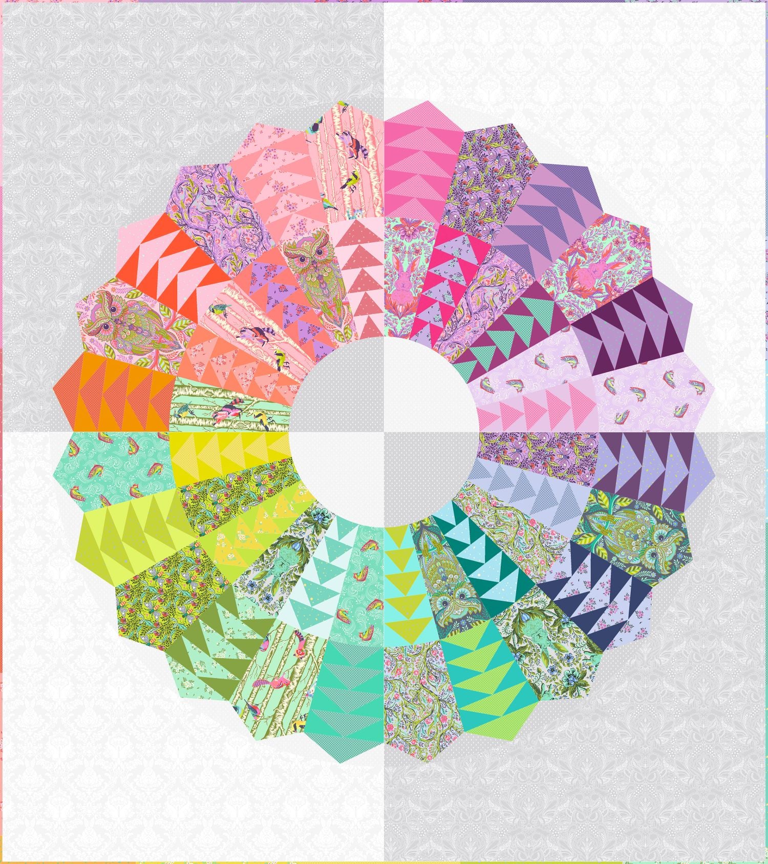 The image is a vibrant and colorful quilt featuring a variety of patterns and shapes, including triangles, circles, and floral designs, all arranged in a circular pattern.