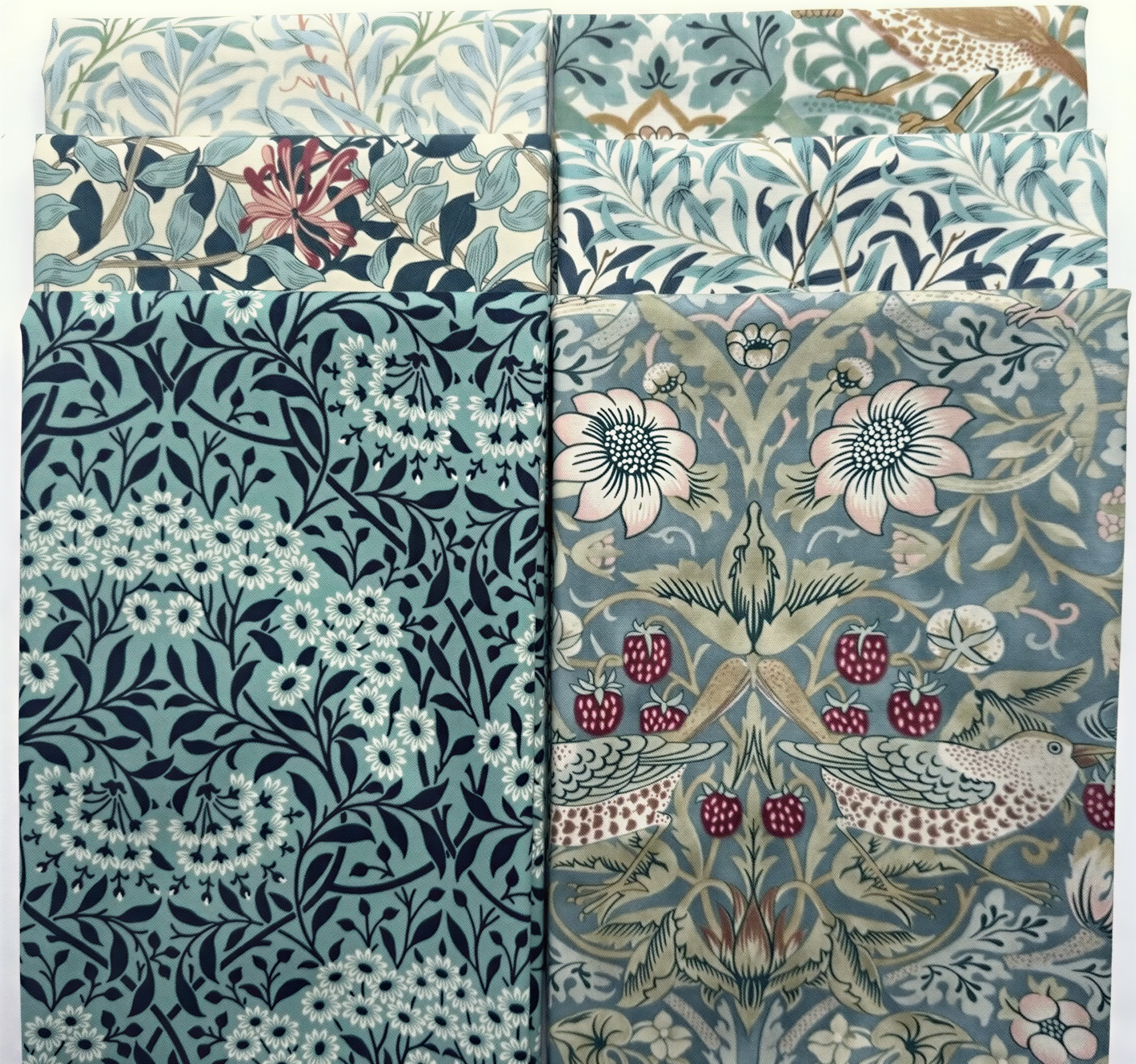 a collection of various patterned fabric swatches, showcasing a range of floral and leaf designs in different colors and styles.