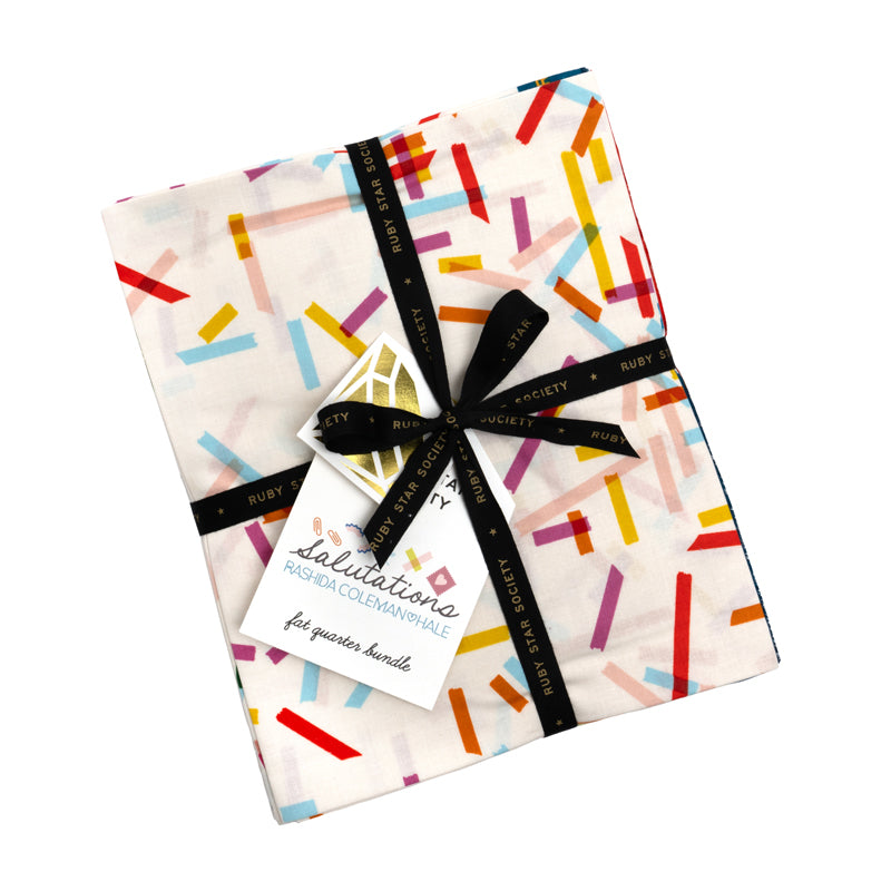 A colorful fabric with a pattern of multicolored lines and shapes, tied with a black ribbon and a tag that reads "Ruby Star Society" and "Salutations for quarter bunches".